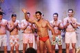 Zak W. gives a wave to the appreciative crowd during the swimsuit portion of the Mr. America contest on The Bachelorette.