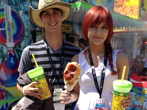 Tom Newman and Kirstin Nikirk mix their food groups Tuesday with pizza on a stick and fresh squeezed lemonade.