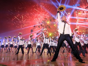 The Young Canadians salute the crowd at the TransAlta Grandstand show at the Calgary Stampede on Friday.