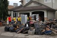 A group of volunteers, the Mormon Helping Hands assist with basement cleaning in High RIver on July 5.