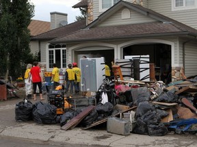 A group of volunteers, the Mormon Helping Hands assist with basement cleaning in High RIver on July 5.