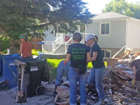 Volunteers from Wood's Homes help clean up in Bowness.