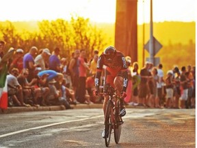 A rider heads up Fortway Dr. hill as the sun started to set behind the High Level Bridge near the Legislature, on the Tour of Alberta, Pro Cycling race with a one at a time individual time trial through Alberta’s capital city, Edmonton, September 3, 2013.