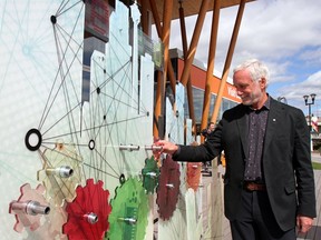 Beakerhead co-founder Jay Ingram adds a gear to a display earlier this year at an announcement for the event. Lorraine Hjalte, Calgary Herald.