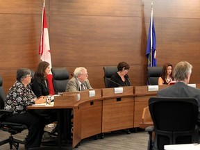 Calgary Board of Education trustees hold in a meeting.
