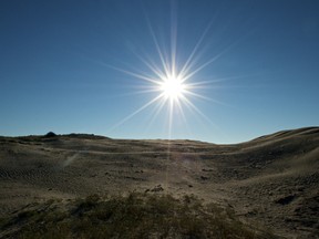 The sun rose over Saskatchewan's Great Sand Hills and dried out the dew saturated sand. Photo by Brendan Troy.