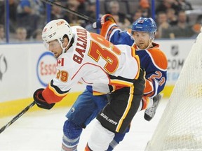 Linus Omark of the Edmonton Oilers, collides with TJ Galiardi of the Calgary Flames at Rexall Place.