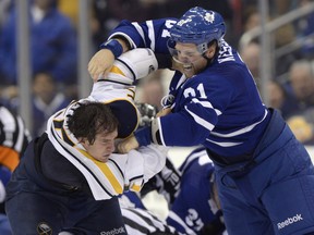 Buffalo Sabres' Brian Flynn fights Toronto Maple Leafs' Phil Kessel during third period NHL hockey action in Toronto, Sunday Sept. 22, 2013.