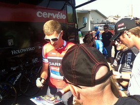 Ryder Hesjedal signs autographs for fans prior to Friday's stage three start of the Tour of Alberta in Strathmore.
