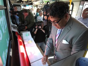 Mayor Naheed Nenshi cast his vote while visiting the mobile voting station aboard a Calgary Transit bus at the Brentwood LRT
(Colleen De Neve/Calgary Herald)