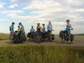 Riders on the Badlands to Banff expedition by Two Wheel View take a break on Highway 1A near Cochrane earlier this year.