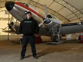 Mikey McBryan, of Ice Pilots NWT, poses next to the first DC-3 his father, Joe, bought. The plane is now at the Aero Space Museum of Calgary. Joe McBryan traded the museum the DC-3 for an IQM (The Dambusters DC-4).