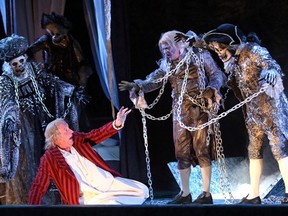 Stephen Hair as Scrooge, centre is joined onstage by Graham Percy, left, Kendra Braun, Robert Klein and Karl Sine in Theatre Calgary's production of A Christmas Carol.