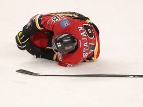 Calgary  Flames Matt Stajan injured on the ice during their game at the Scotiabank Saddledome on December 23, 2013. (Leah Hennel/Calgary Herald)