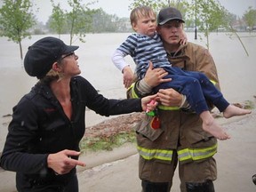 Stuart Gradon/Calgary Herald

HIGH RIVER, AB: JUNE 20, 2013 - Shylow Romaniak hands off her son to Kenny Cummingson to be placed on a combine harvester that was being used to evacuate people stranded at the Co-op supermarket on 12 Ave. S.E. in High River, Alberta Thursday, June 20, 2013. The town of High River was hit by massive flooding Thursday.


(Stuart Gradon/Calgary Herald)

(For City story by TBA)
00046226A