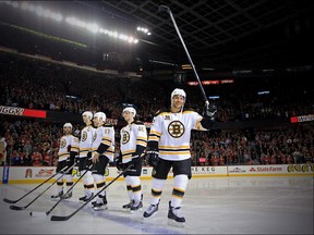 The Boston Bruins' Jarome Iginla salutes the crowd during a long standing ovation in his honour before his team's game against the Calgary Flames at the Scotiabank Saddledome in Calgary Tuesday, December 10, 2013. This was Jarome Iginla's first game back in Calgary since being traded away from the team last season.

(Stuart Gradon/Calgary Herald)