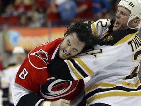 Carolina Hurricanes' Kevin Westgarth (8) and Boston Bruins' Shawn Thornton (22) fight during the first period of an NHL hockey game in Raleigh, N.C., Saturday, April 13, 2013.