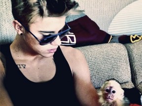 Justin Bieber plays with his monkey in happier times.