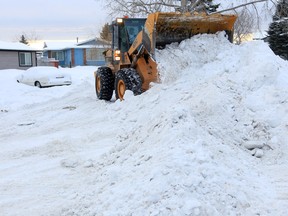 Snow is collected for removal on Midlawn Place S.E. Stuart Gradon/Herald

(For City story by TBA)
00051854A