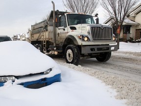 A City of Calgary plows works on a snow clogged street in Prestwick Tuesday afternoon January 7, 2014. (Lorraine Hjalte/Calgary Herald)