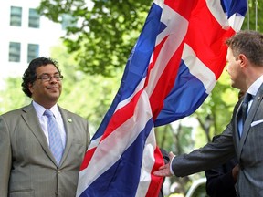 Nenshi raises the Union Jack at Calgary City Hall with UK Consul-General Tony Kay, to mark the London Summer Olympics. Grant Black/Herald