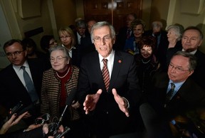 Senate opposition leader James Cowan, flanked by the New Power Generation. Canadian Press