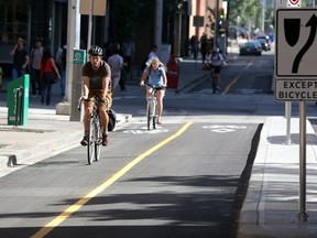 That's three ! Three cyclists on Calgary's first separated bike lane on 7th Street S.W.  last July. Hah ah ah!