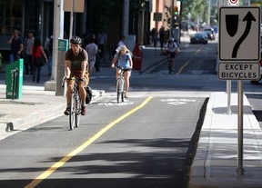 That's three ! Three cyclists on Calgary's first separated bike lane on 7th Street S.W.  last July. Hah ah ah!