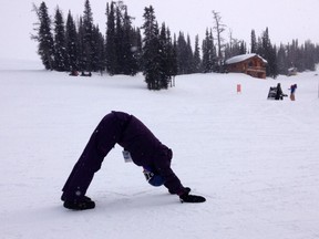 Woman doing yoga outdoors in winter