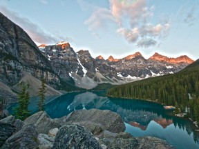 As the sun rose, the mountain tops turned a crimson red in the early morning light. Moraine Lake never looked so good. Photo by Brendan Troy.