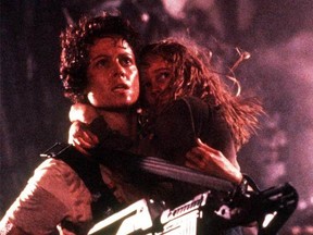 Ripley (Sigourney Weaver) takes on the role of Newt's (Carrie Henn's) protector in Aliens.