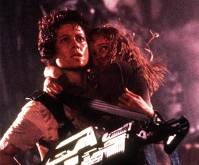 Ripley (Sigourney Weaver) takes on the role of Newt's (Carrie Henn's) protector in Aliens.