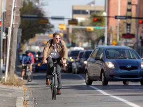 A cyclist makes his way along 10th Avenue SW during the afternoon rush hour.
Colleen De Neve/Herald
