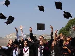 LONDON, UNITED KINGDOM - JULY 18:  Graduates celebrate after leaving their graduation ceremony at the Royal Festival Hall on the Southbank in high temperatures on July 18, 2013 in London, England. The United Kingdom is experiencing a second week of heatwave conditions.  (Photo by Oli Scarff/Getty Images)