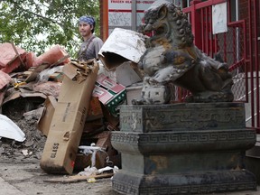 Volunteers help clean up the in Chinatown on June 25. Leah Hennel/Herald