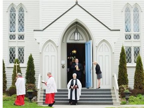 Funeral director Jamieson Ross, back centre, carries the ashes of world renowned author Farley Mowat during Mowat's funeral in Port Hope, Ont., on Tuesday, May 13, 2014. THE CANADIAN PRESS/Nathan Denette