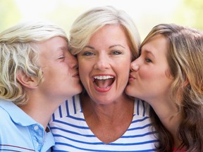 Woman Being Kissed By Her Teenage Children