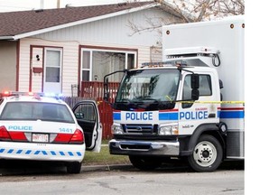 A police presence remains at the scene of a double homicide in Penbrooke Meadows in Calgary on May 5, 2014.
