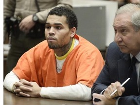 R&B singer Chris Brown appears with his attorney Mark Geragos (R) in court for a probation violation hearing at Los Angeles Superior Court in Los Angeles, California,  May 1, 2014.  During a probation violation hearing May 9, 2014 Chris Brown was sentenced to an additional year in jail, serving another 131 days after credit for days already served.