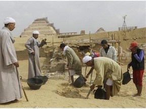 Archaeology workers dig at the site of a newly-discovered tomb dating back to around 1100 B.C. at the Saqqara archaeological site, 30 kilometers (19 miles) south of Cairo, Egypt, Thursday, May 8, 2014. Antiquities Minister Mohamed Ibrahim said Thursday that the tomb belongs to a guard of the army archives and royal messenger to foreign countries. Ibrahim says the Cairo University Faculty of Archaeology’s discovery at Saqqara adds “a chapter to our knowledge about the history of Saqqara.” Saqqara was the necropolis for the ancient Egyptian city of Memphis and site of the oldest known pyramid in Egypt.(AP Photo/Amr Nabil)