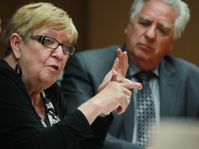 Helen Rice, president of the Alberta Urban Municipalities Association, speaks with the Calgary Herald. Coun. Jim Stevenson, brow ever furrowed, looks on. Gavin Young/Herald