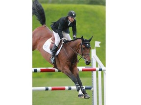 Canada’s Eric Lamaze rode Power Play to first place in the $85,000 Spectra Energy Cup jump off at Spruce Meadows on Thursday evening.