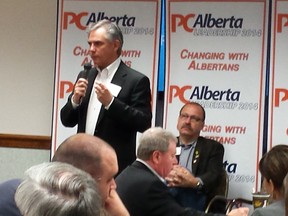 Jim Prentice speak as Rick McIver looks on at the Southern Alberta stop on the PC Alberta Policy Forum tour in Lethbridge on Saturday.