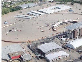 Two weeks before opening day of the 2013 edition of the Calgary Stampede, the grandstand and adjacent grounds lie under the waters of the flooded Elbow River as seen from the air Friday.