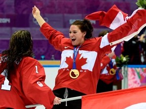 Natalie Spooner, right, seen here celebrating  the women's gold medal hockey game win at the Sochi Winter Olympics, is competing on the second season of The Amazing Race Canada with teammate Meaghan Mikkelson. The show premieres July 8 on CTV.