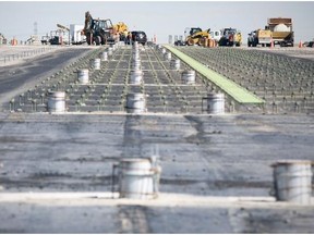 Workers at the site of the Calgary airport runway project in August 2012. More than 11,000 Calgarians will be able to spend Father’s Day enjoying what is likely to be a once-in-a-lifetime experience at this weekend’s Run & Roam the Runway Events.