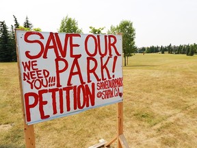 A petition sign stands in a park that is slated for a francophone school in Scenic Acres. Some residents are opposed to a school being built on the side because it will take up some of the current park space.