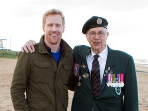 Host Jon Montgomery and Canadian veteran Jim Parks wait for the teams on Juno Beach on The Amazing Race Canada.