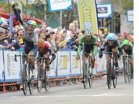 Daryl Impey from South Africa celebrates as he crosses in first at the finishline during Stage 5, a 124 km 11 lap circuit through downtown Edmonton at the 2014 Tour of Alberta in Edmonton, September 7, 2014. He also wins race leader for the Tour