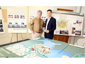 Alan Copithorne, left, president Elbow River Land Corp., and Birol Fisekci, president and CEO of Bordeaux Properties, stand near a map of the new community of Harmony, which will break ground shortly. Qualico Communities has joined the partnership.